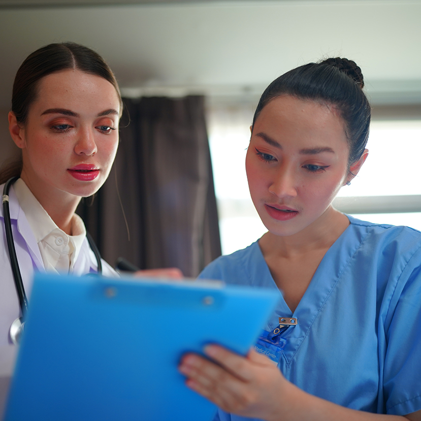 Young female medical student working at the hospital and medical staff