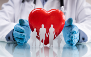 Healthcare worker with hands around a heart and family